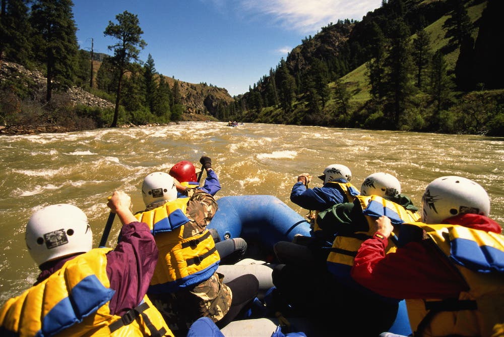 Rafting the Salmon River, Idaho Six white water rafters navigating the brown rapids of the Salmon River along the Salmon River Trail.
