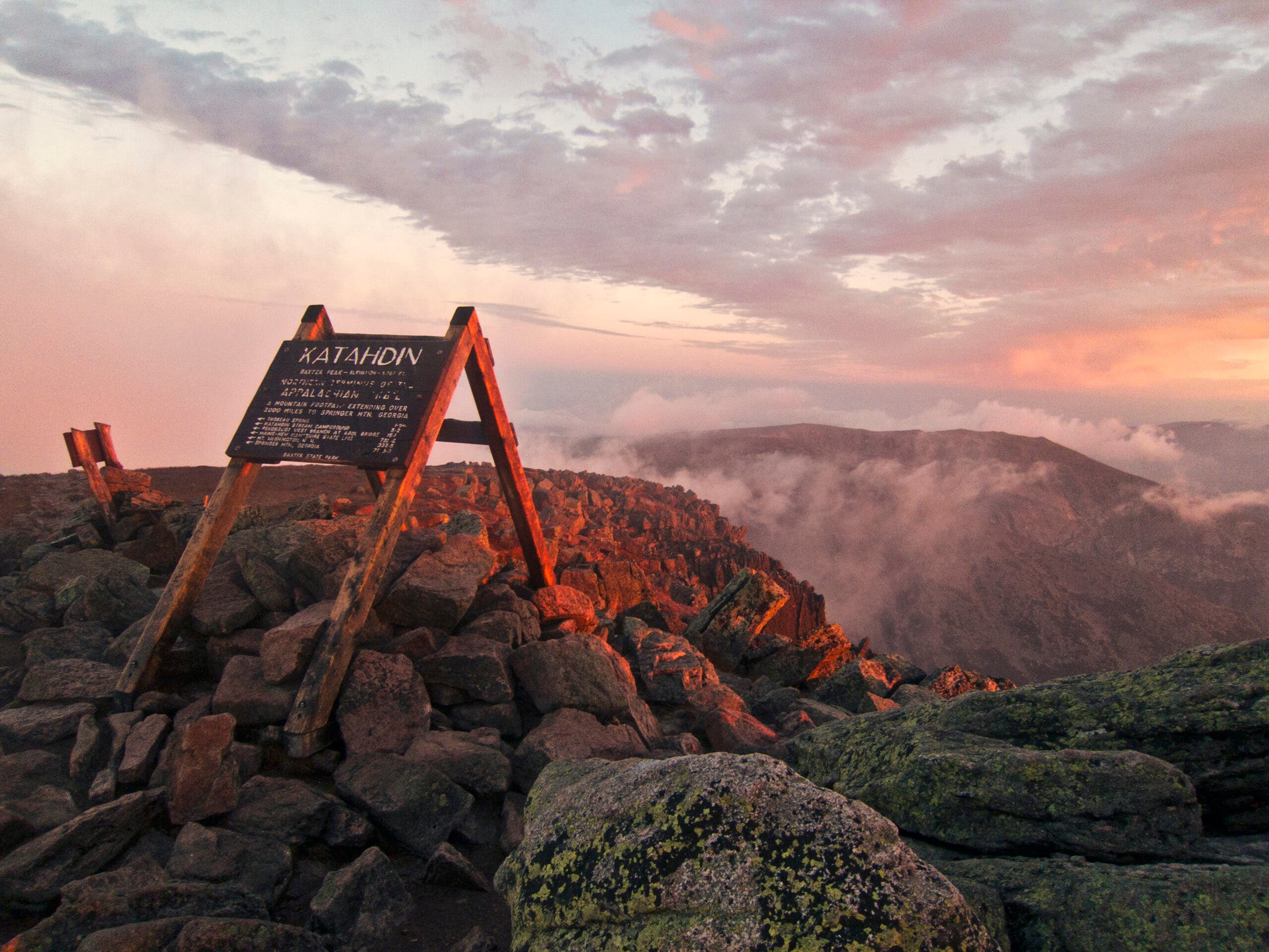 The summit sign on Maines Mount Katahdin seen at sunrise.