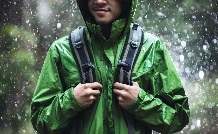 man hiking in the rain