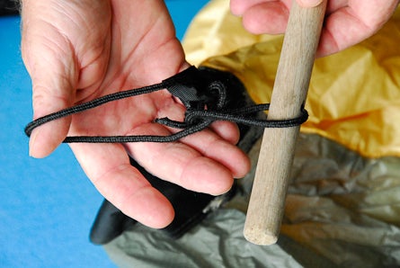 4) Slip the dowell through the cord loop. None