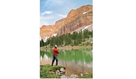Hiker fishing at Dead Horse Lake along the Highline Trail in Utah. 