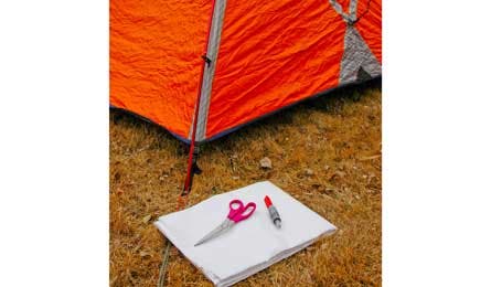 You'll need: Your tent,  with the floor pitched tightly. Scissors, a waterproof marker, and a sheet of Tyvek.
