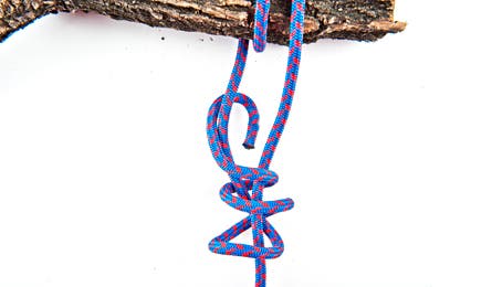 Knot-5 445x260 38227 Feed the working end through the middle of the top two loops, over the bottom loop, then back through the hole.