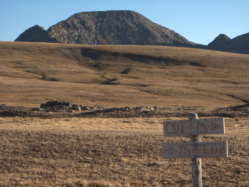 An alpine meadow with mountains in the distance between Stony Pass and Celebration Lake on the Colorado Trail. 