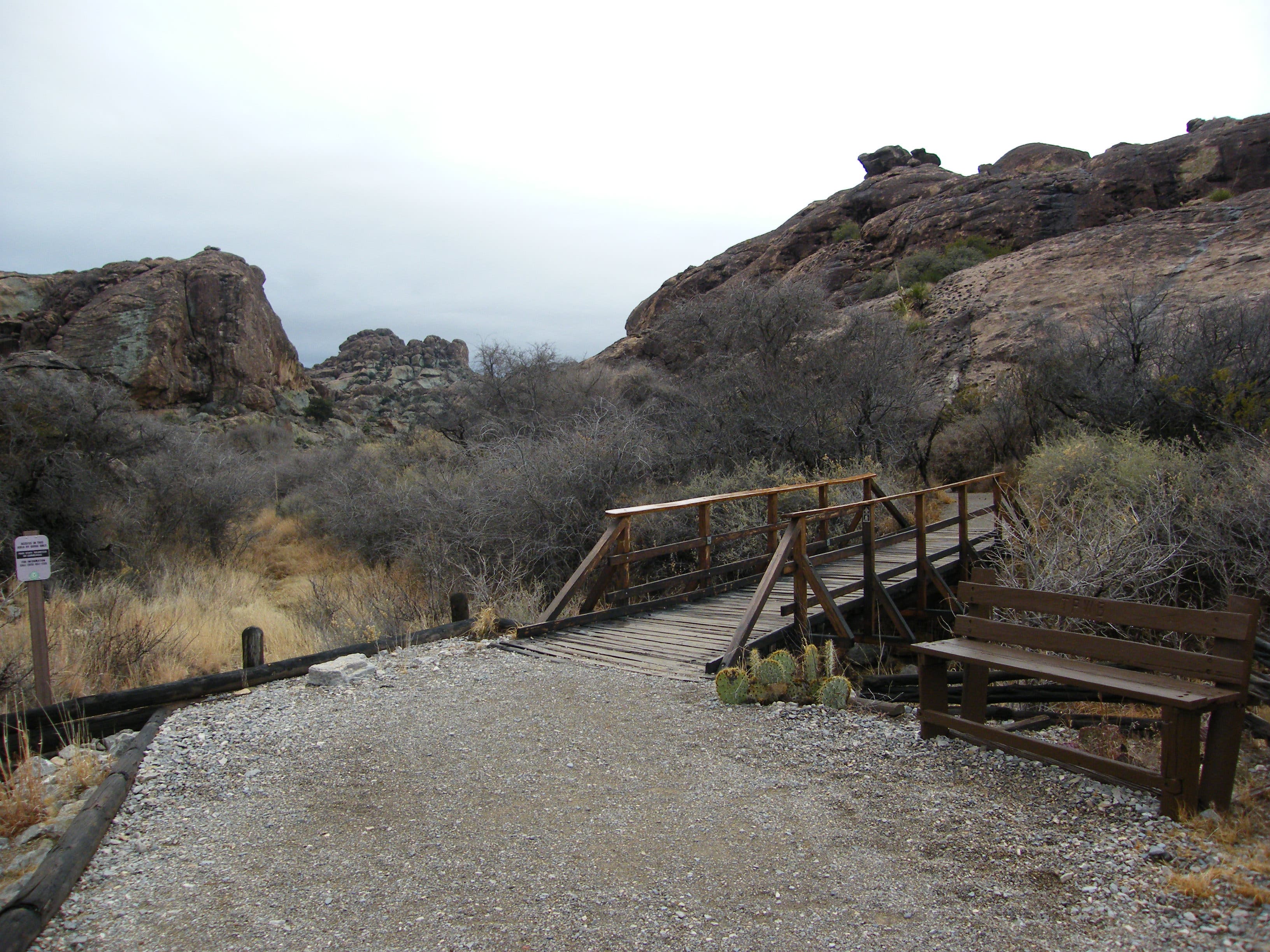 Bench overlooking rock shelter. None