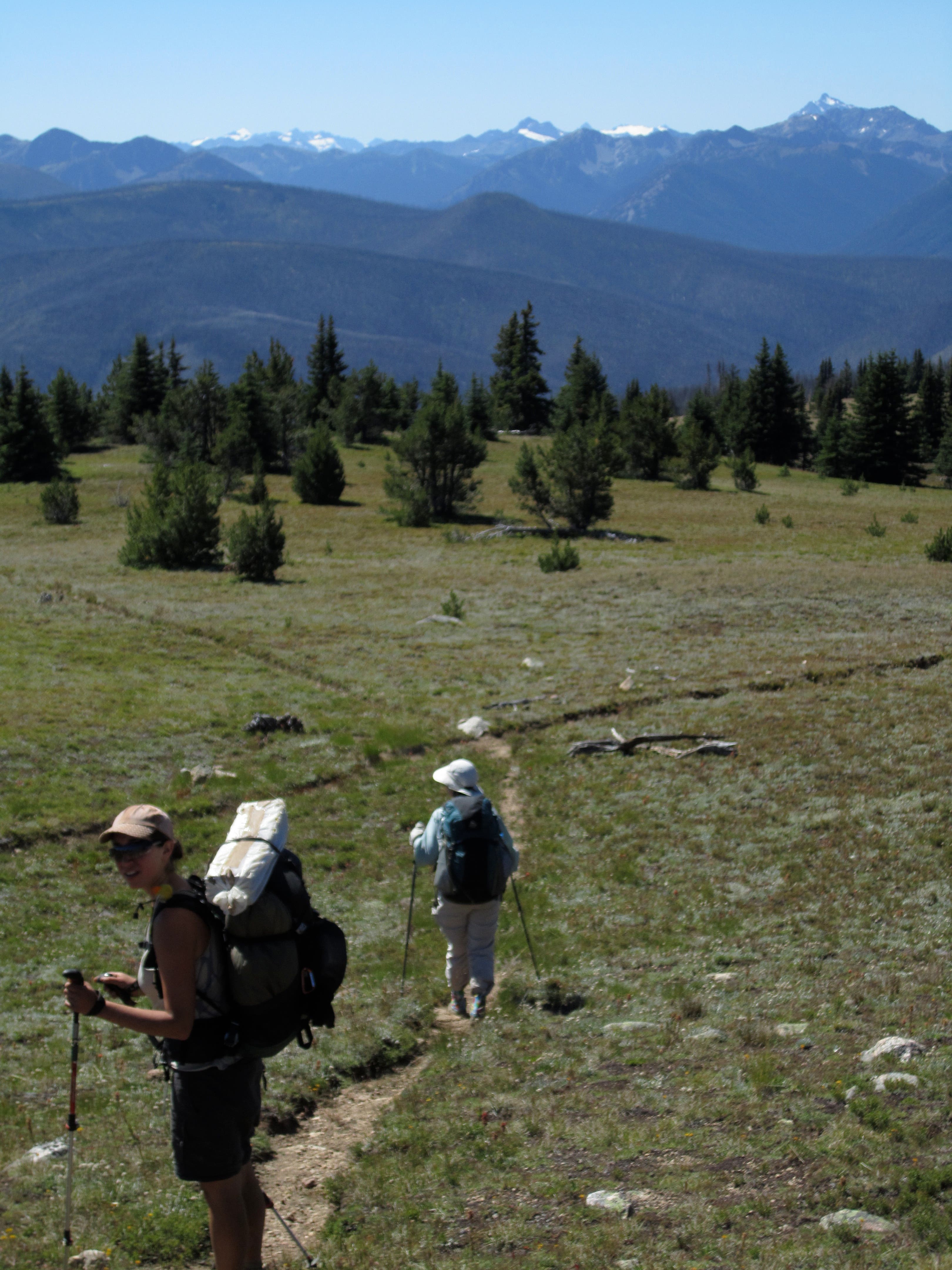 Bunker Hill has a top 10 PNT view from its peak. Hikers moving along singletrack on Bunker Hill taking in the beautiful views on their way to Ross Lake.