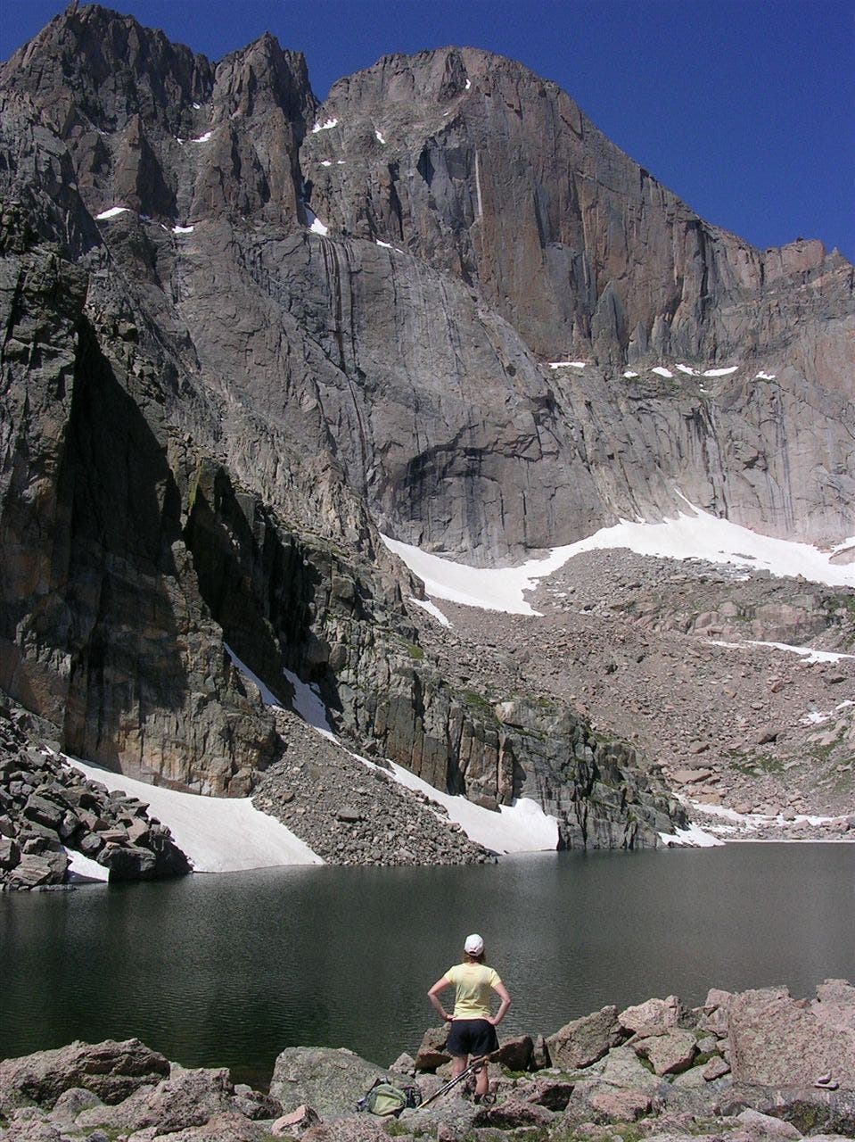 The terminus of the Chasm Lake Trail Longs' 1,000-foot Diamond Face towers over the glacial waters of Chasm Lake.
