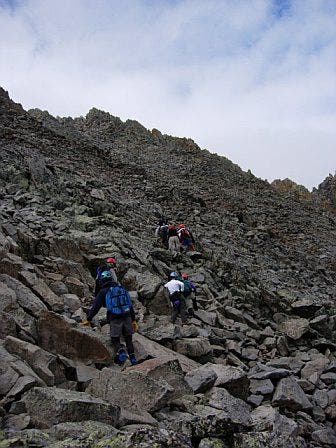 Climbing boulders to reach the ridge None