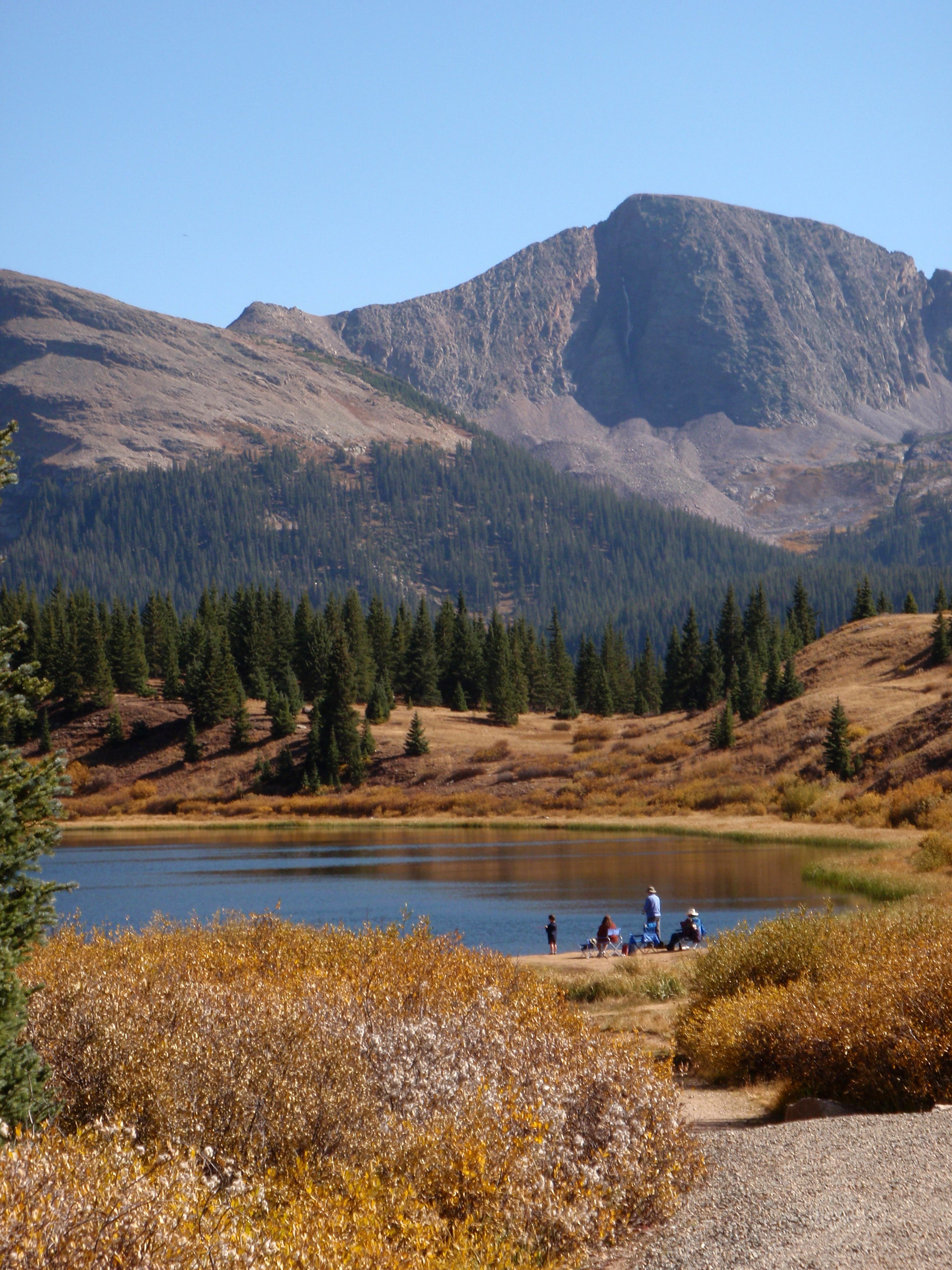 Molas Lake is a great camping and fishing spot along the Colorado Trail. A group of four fishing on the shores of Molas Lake along the Colorado Trail.