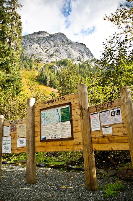 Hannegan Campground Trailhead at the beginning of the hike from Copper Ridge to Beaver Trail. Wooden trail sign for Hannegan Pass that marks the start of the hike in Hannegan Campground.