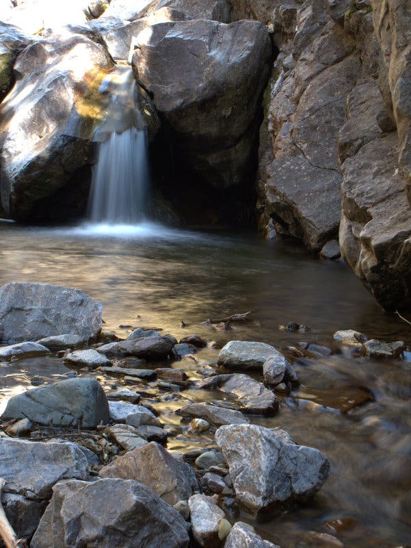 A waterfall cascades into a small pool off the sides of the Colorado Trail just outside of Stony Pass. 