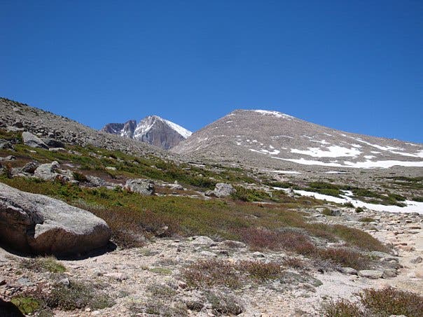 Views of Longs Peak And Mount Lady Washington both with patches of snow. 