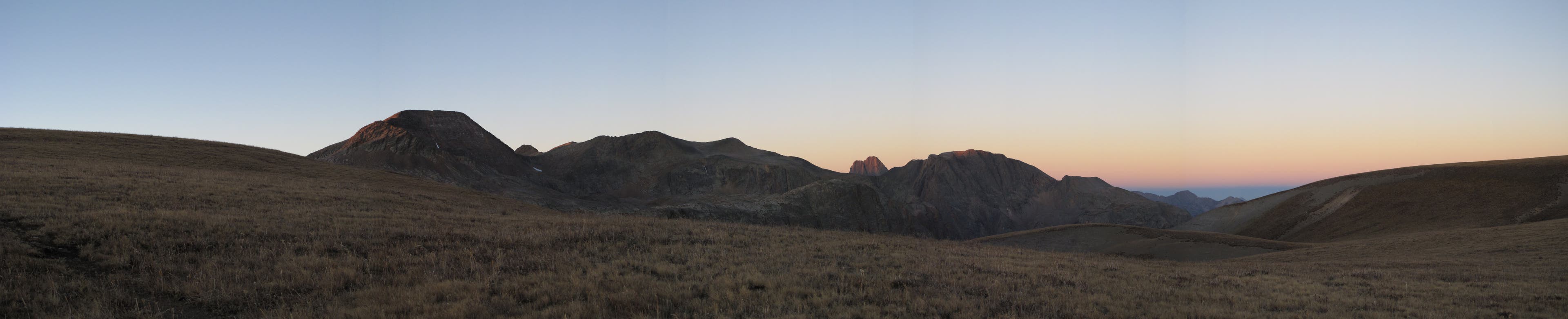 The 40-mile section of the Colorado Trail between Stony Pass and Celebration Lake doesn't have a lot of trees in some sections and so offers big views. Distant views of mountains from across a wide-open field.