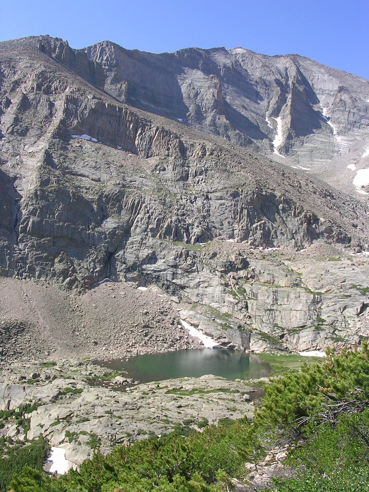 A small pond called Peacock Pool sits nestled beneath the mountains. 