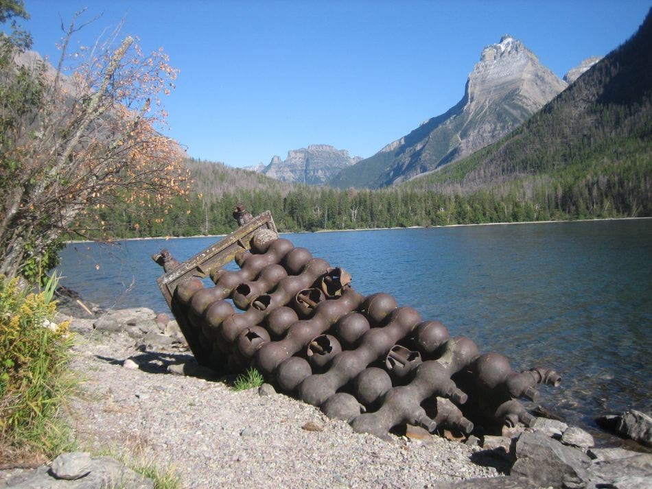 An old, half-buried oil precipitator on the beach at Kintla Lake. Precipitator An old, half-buried oil precipitator on the beach at Kintla Lake.
