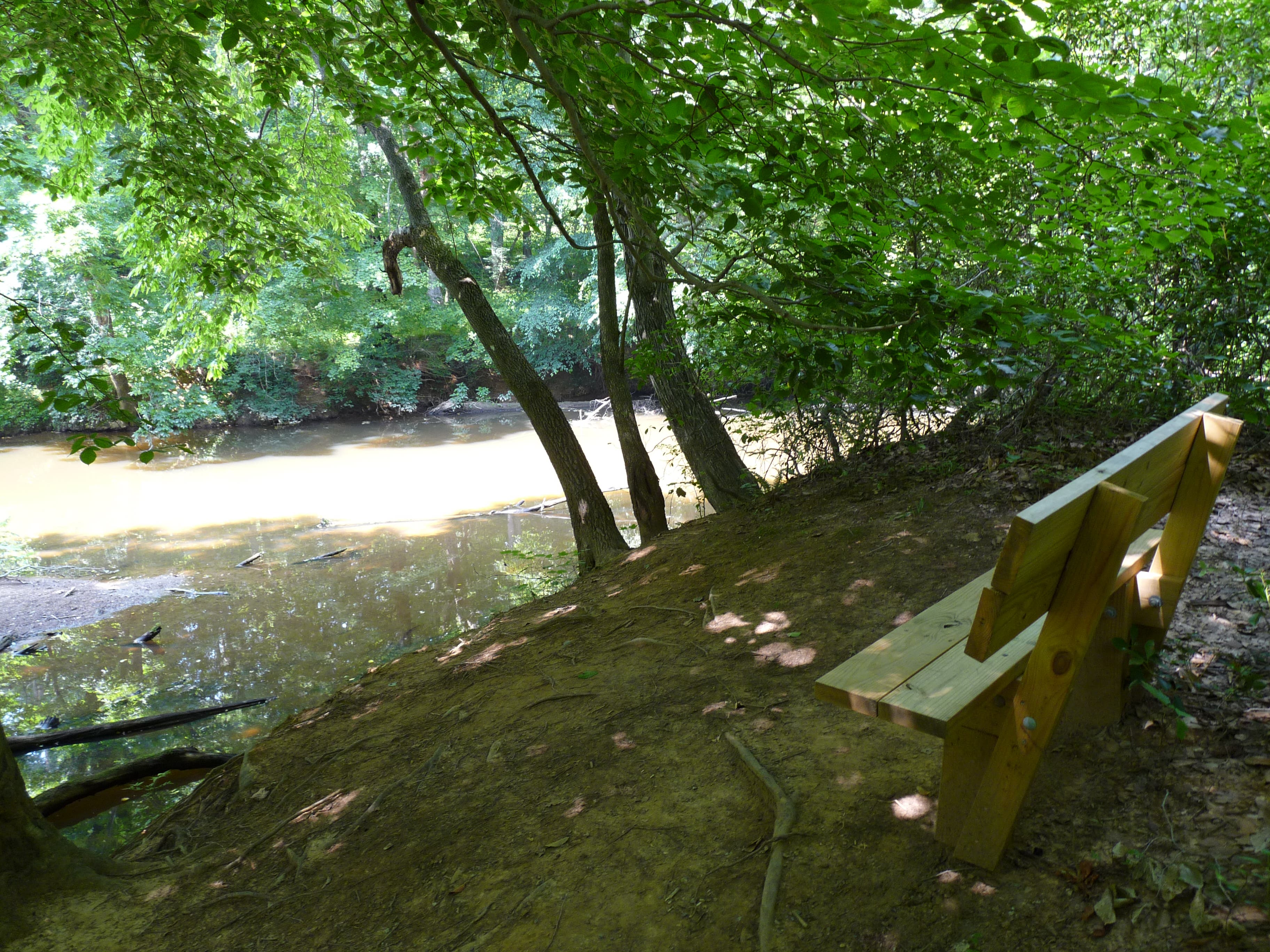 Resting bench with a river view None