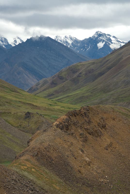 Ridges frame snowy mountains None