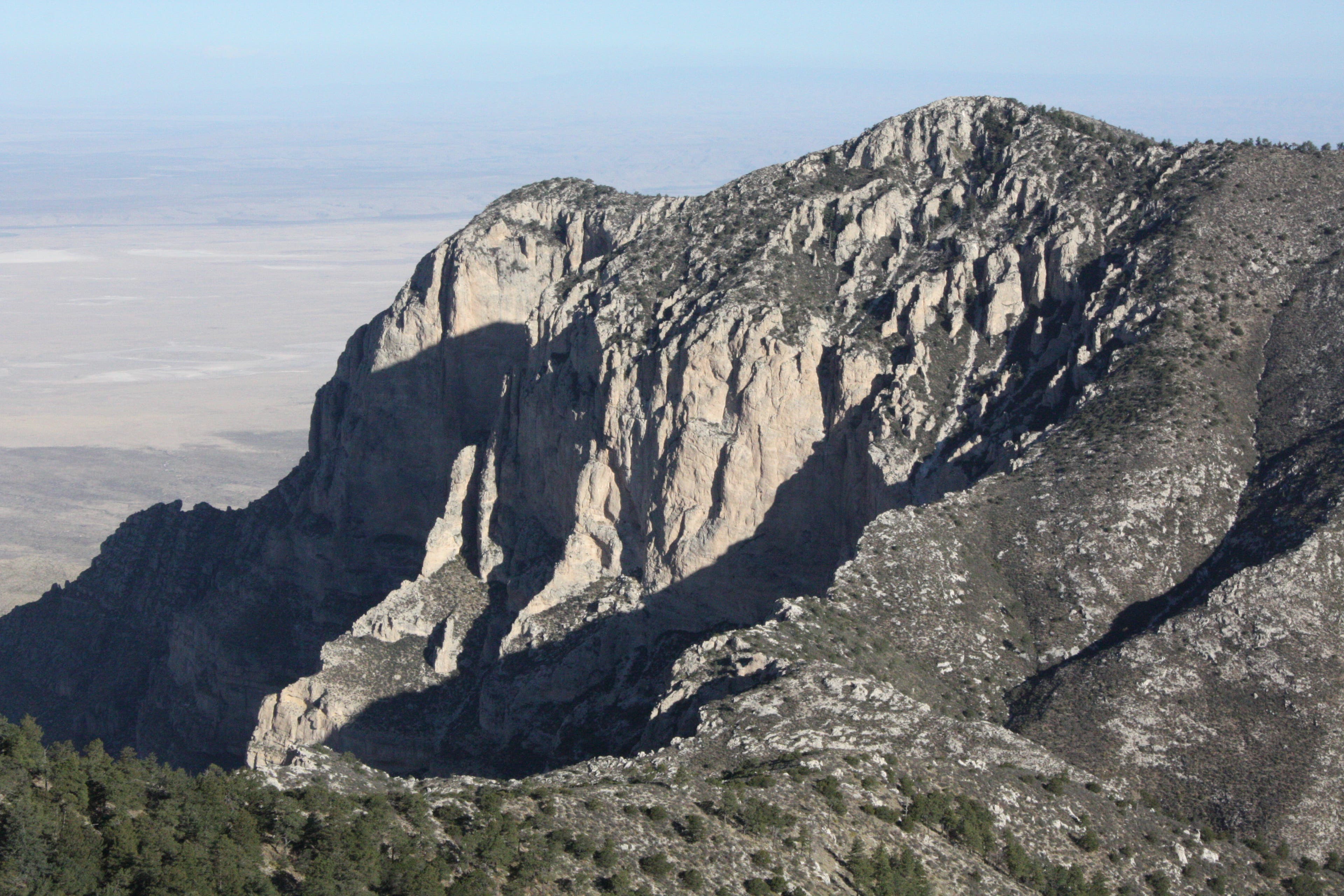 Views of Shumard Peak from the Guadalupe Peak Trail. Views of Shumard Peak from the Guadalupe Peak Trail with desert in the distance.