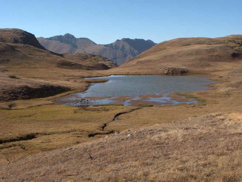 At the beginning of the Colorado Trail section, a small alpine lake with mountains in the background between Stony Pass and Celebration Lake.