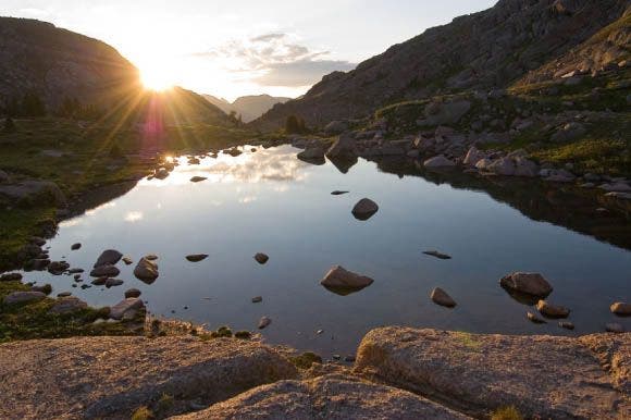 Sunlight Lake, Weminuche High Route Trail, San Juan Mountains The sun rises and reflects off Sunlight Lake on an early morning while hiking the Weminuche High Route Trail.