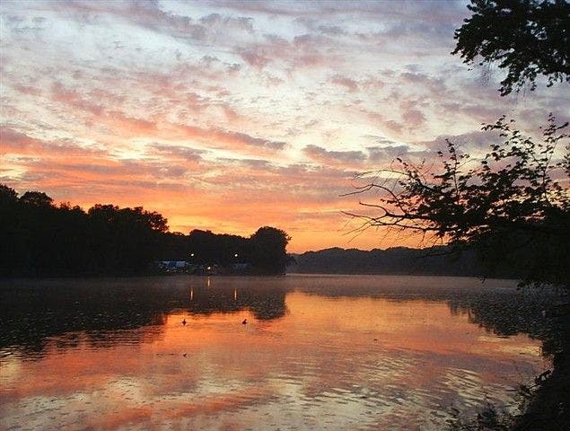 Sunrise reflected on glassy waters None