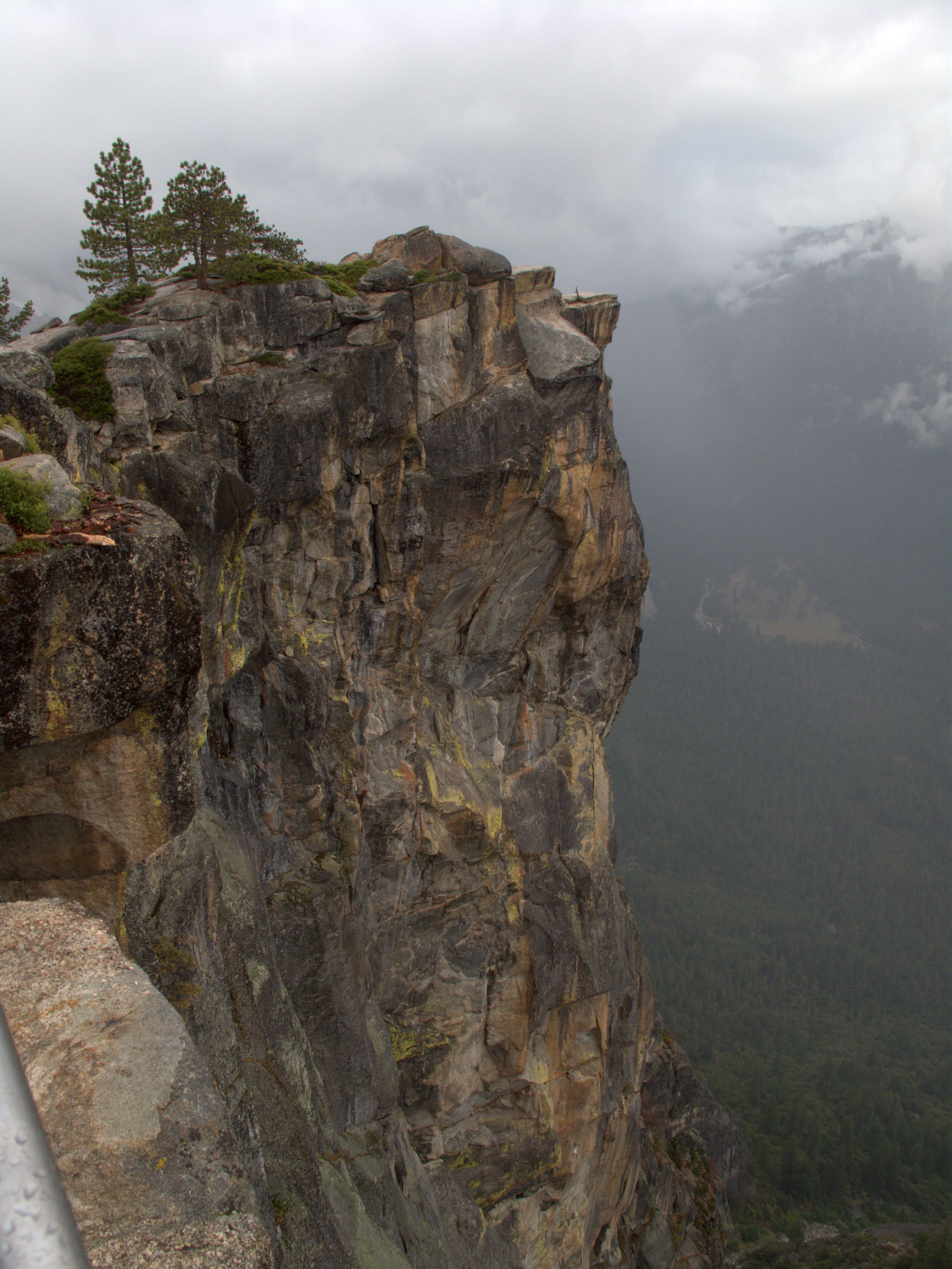 Taft Point as seen from the Pohono Trail to the southeast. Taft Point juts out precariously over the cloud-covered valley below.