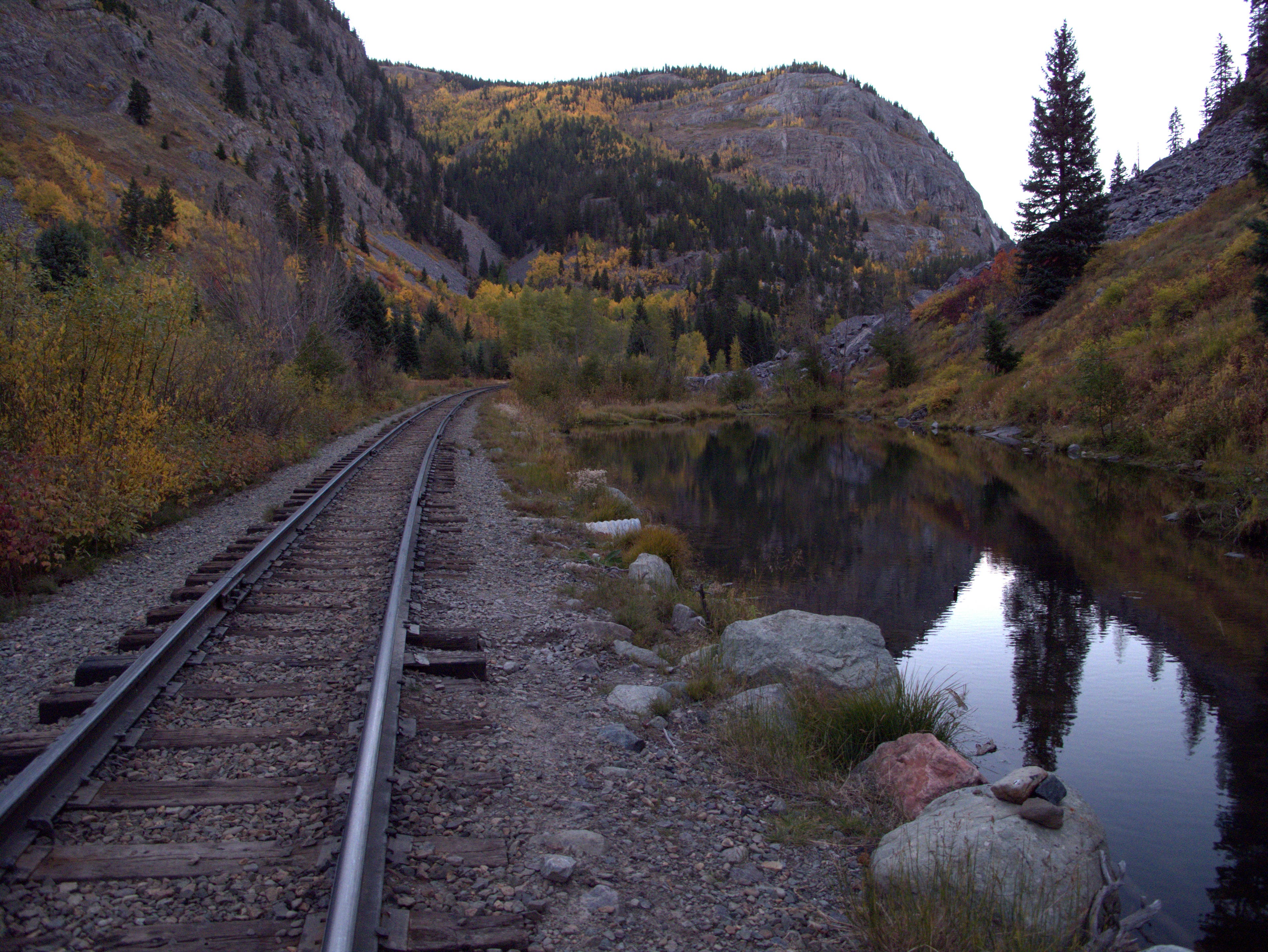 The Durango-Silverton narrow nauge tracks along the Stony Pass to Celebration Lake hike. Durango-Silverton narrow gauge railroad tracks running along a stream and into the mountains in the middle of the Stony Pass to Celebration Lake hike.