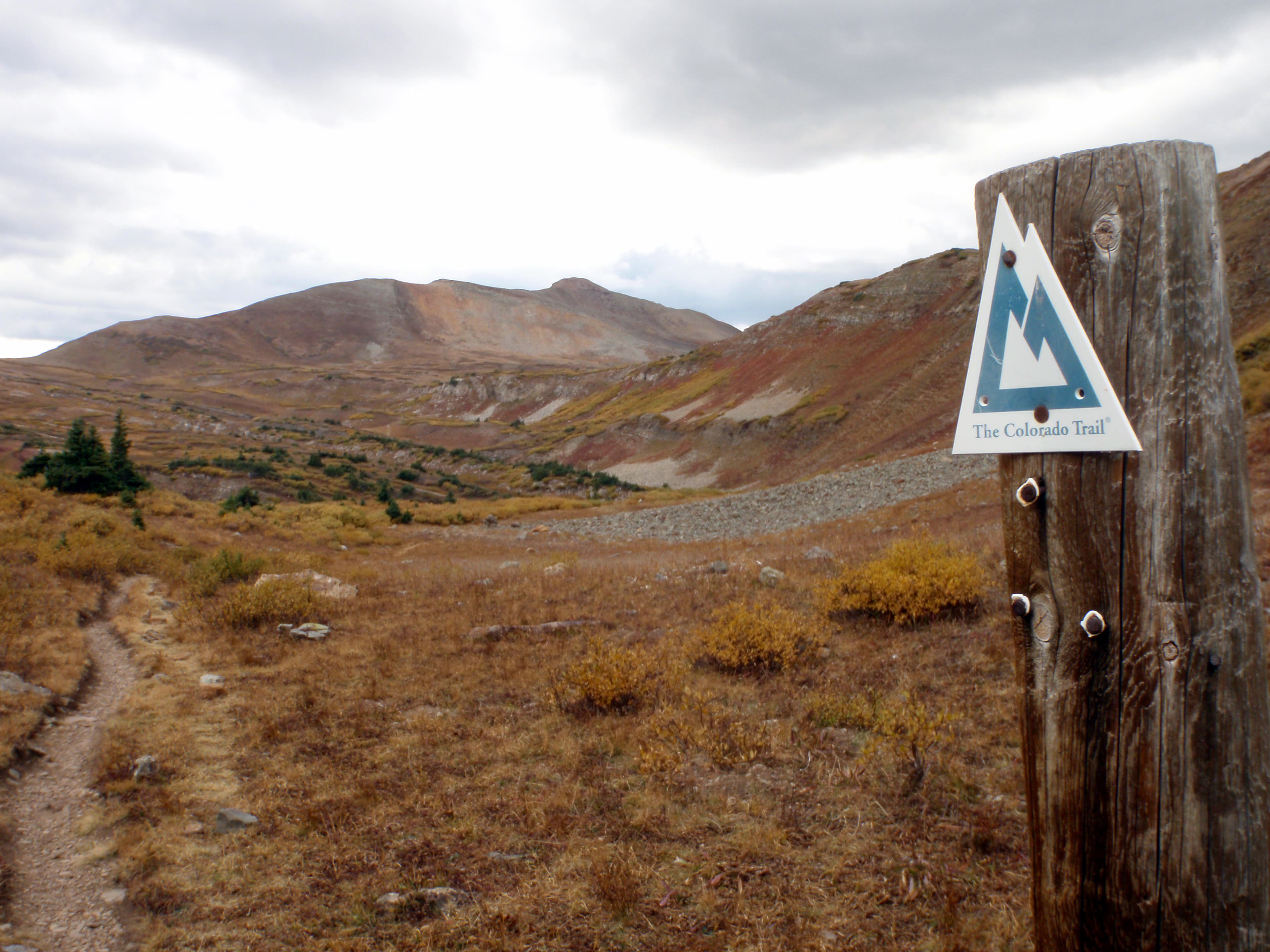 The trail ascending Lime Creek drainage at around mile 20 of the section between Stony Pass and Celebration Lake along the Colorado Trail. A singletrack dirt trail ascending to the Lime Creek Drainage.