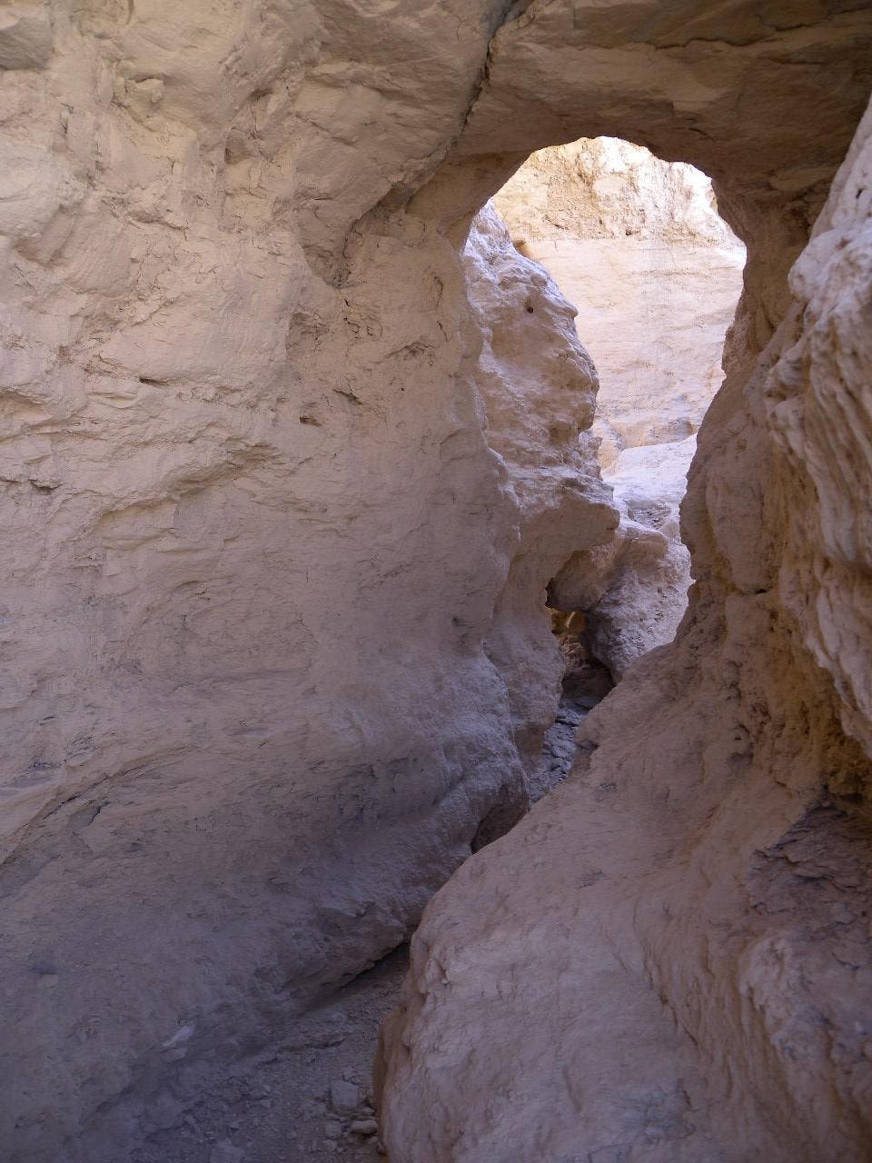 A tunnel through rock on the way up the ridgeline.