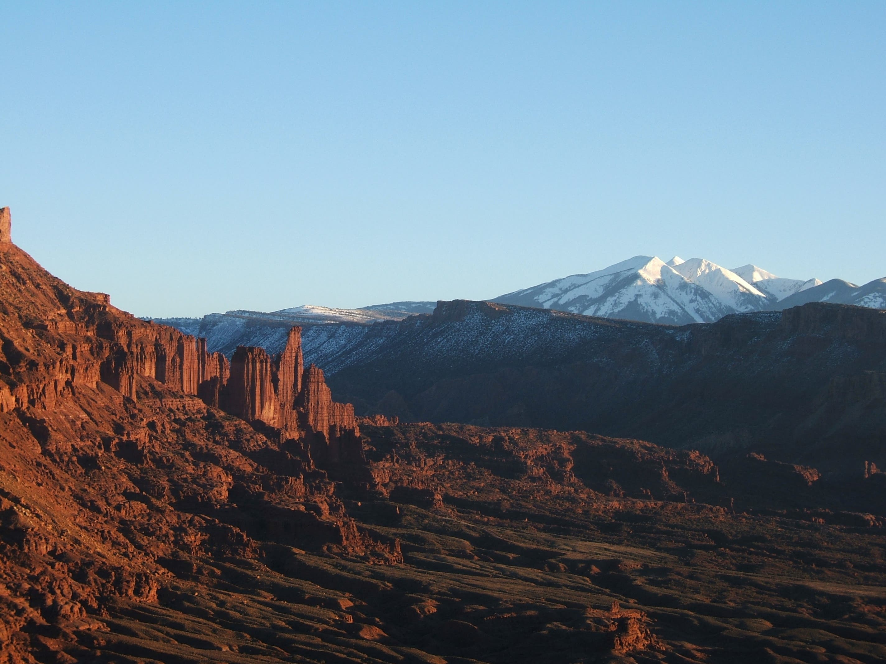 This shot was taken from a cliff we climbed across the Colorado River, about 5 crow miles away from Fisher Towers. It was just about sunset, and the…