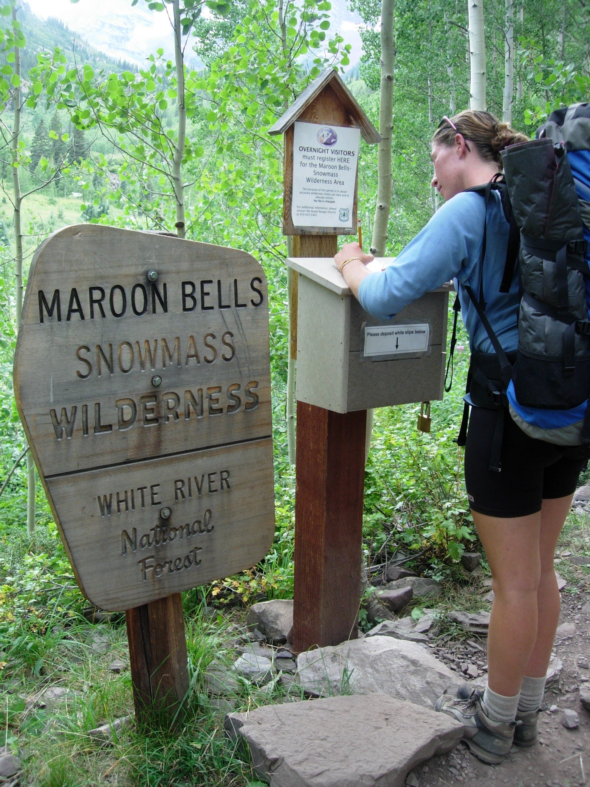 A hiker signs into the Maroon Bells Snowmass Wilderness in the White River National Forest while on the Stewart Lake hike. 