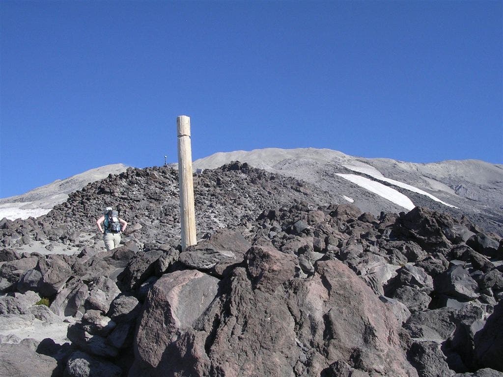 Wooden Post marking the path on the rock/boulder gardens None