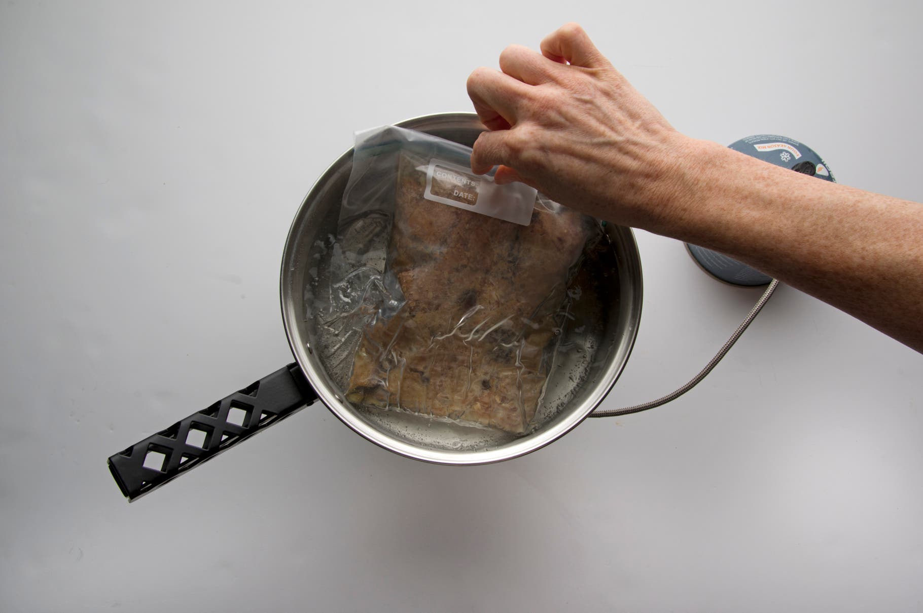 Bread Pudding: Step 5 Seal bag, submerge in boiling water for five minutes on each side or until pudding texture is springy.