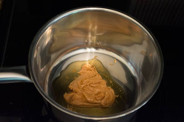 PB&J Cereal: Step 2 In a small saucepan, melt peanut butter and maple syrup over low heat. Remove from burner when liquefied.