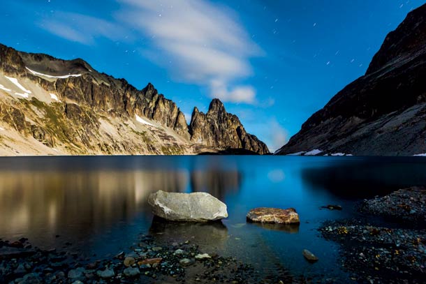 North Cascades National Park - Silver Lake At this alpine lake, with Mt. Rahm, Devils Toothpick, and Devils Thumb (left to right) biting into the sky, the scene is all serenity, stillness, and…