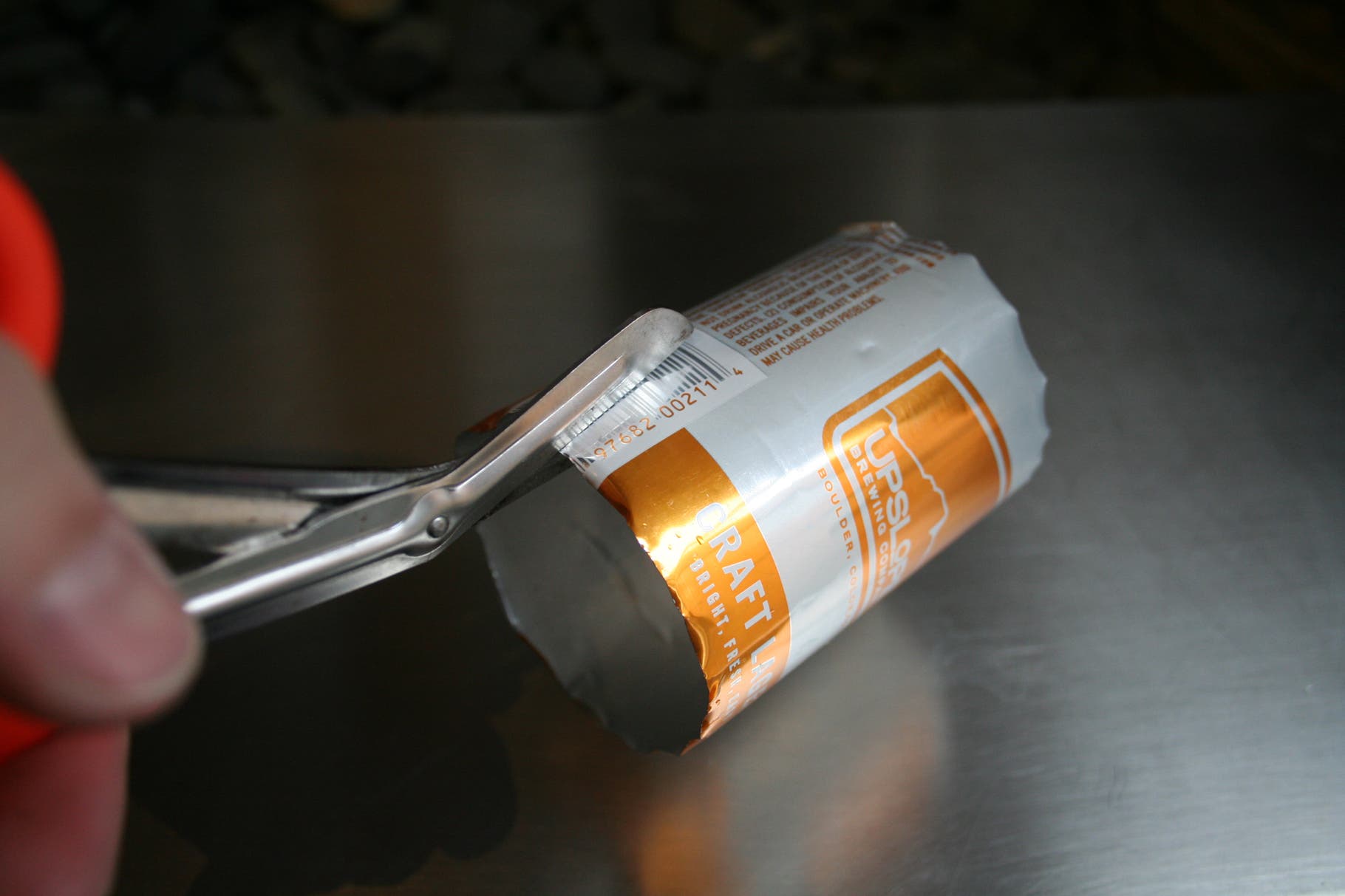 Beer Can Visor: Step 2 Use the knife to cut the tops and bottoms off of the cans.