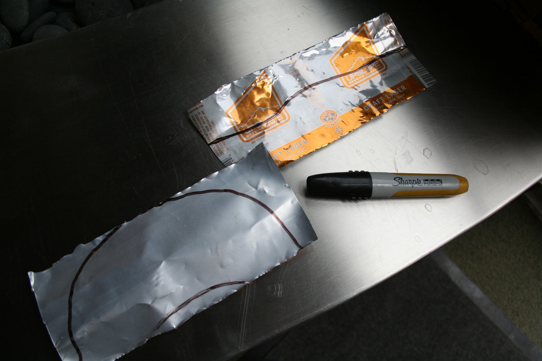Beer Can Visor: Step 4 Use a marker to sketch the shape of the bill on one aluminum piece and the brim on the other.
