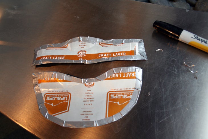Beer Can Visor: Step 7 Rip larger swaths of tape to attach the two pieces and build the strap.