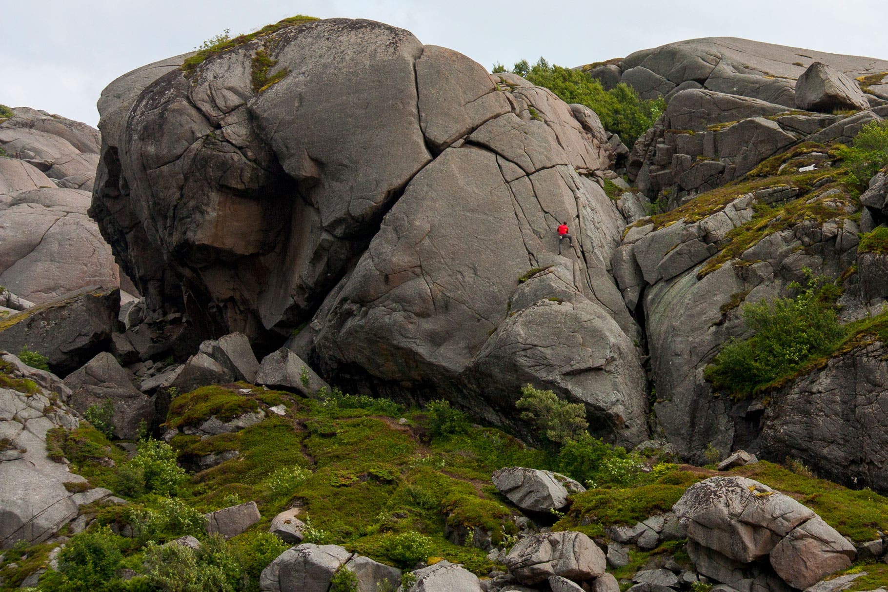 Peter Doucette takes an easy climbing romp up the Butter Arms boulder for a vertical wander in the Paradiset, Lofoten Islands.