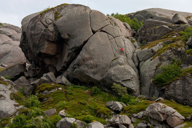 Norway: Paradiset Peter Doucette takes an easy climbing romp up the Butter Arms boulder for a vertical wander in the Paradiset, Lofoten Islands.