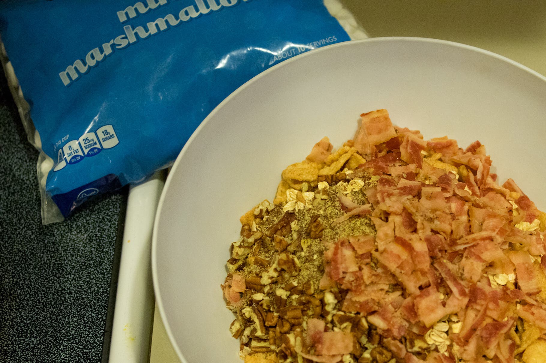 Blend cereal, rolled oats, ground flax seeds, chopped pecans, and bacon in a bowl.
