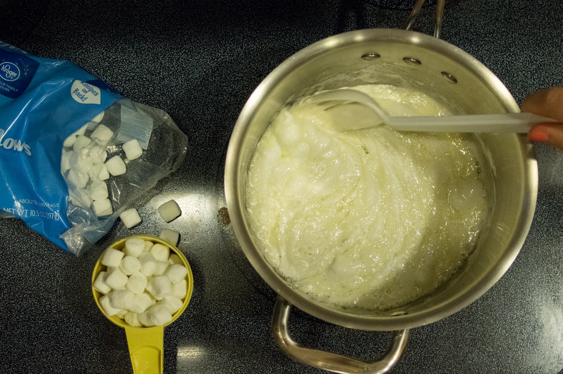 Add marshmallows and melt over medium heat, stirring continuously. As soon as marshmallows are fully melted, remove from heat.