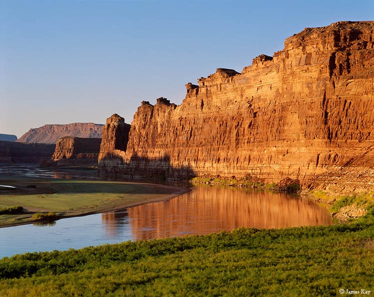 Colorado and Dirty Devil River Confluence Downstream view at sunrise of the free-flowing Colorado River viewed from just below its confluence with the Dirty Devil River. When Lake Powell was…