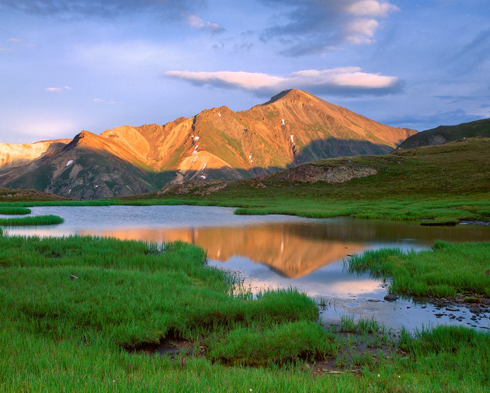 Handies Peak Reflection Handies Peak reflects in a small tarn near Cinnamon Pass in the San Juan Mountains of southwest Colorado.