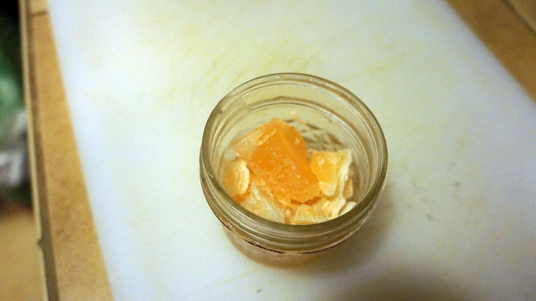 Make a Firestarter-Step 2 Crush your candle, remove the wick, and put it in the jar.