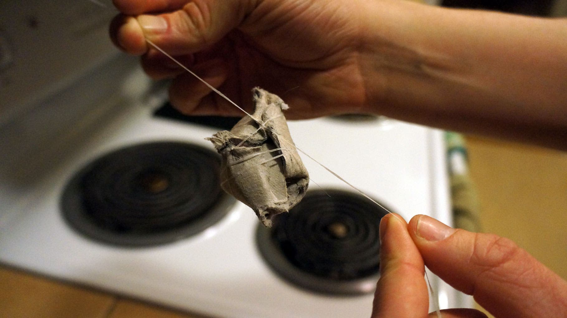 Make a Firestarter-Step 6 Tie it shut with floss, leaving about an 8-inch tail for dipping.