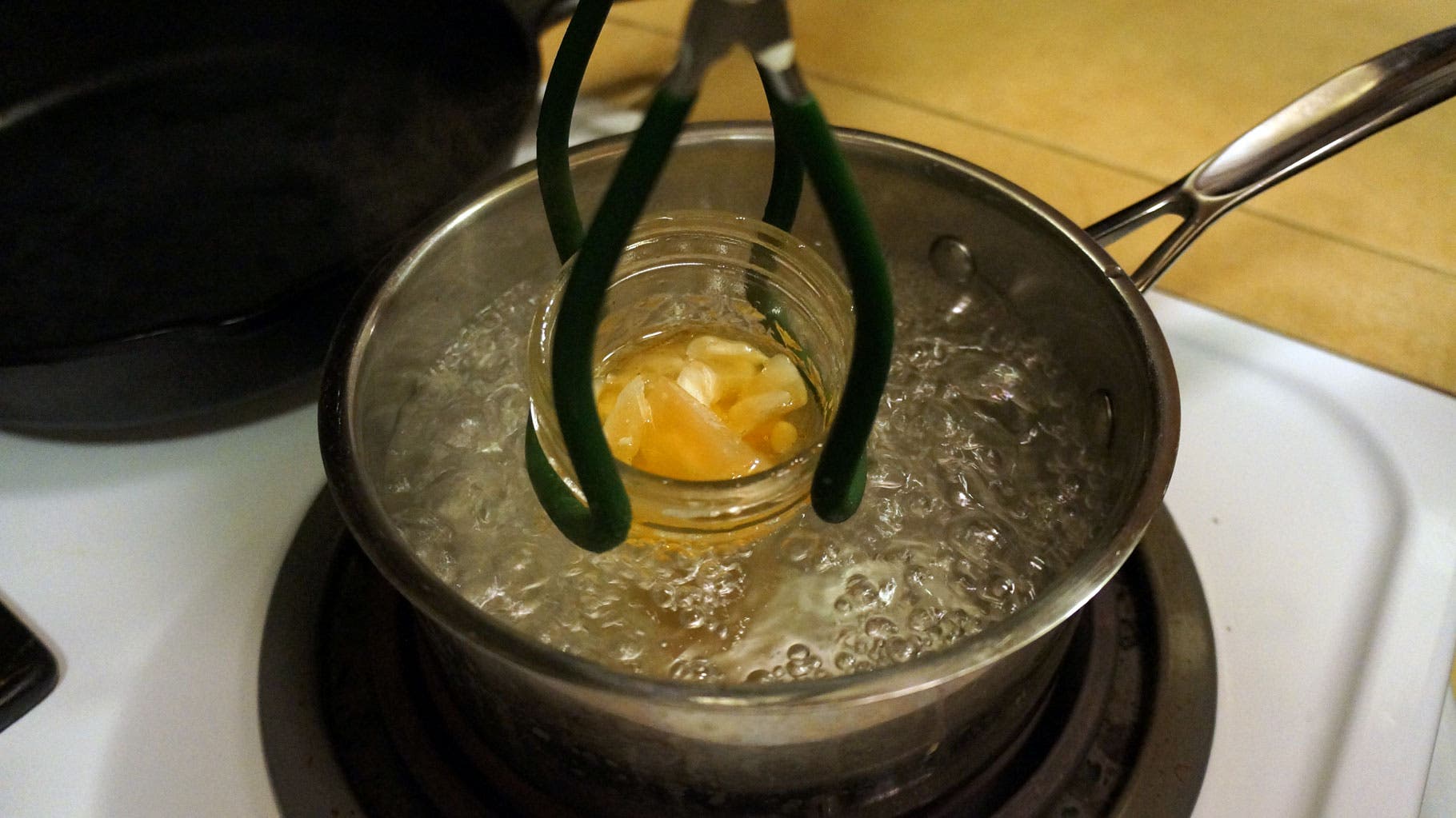 Bring a pot of water to boil (make sure the water level is an inch or so below the top of your jar). Using tongs, hold the jar steady in the boiling…