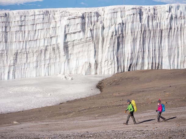 Lead guide Peter Whittaker and his daughter Gabriella are dwarfed by the Rebmann Glacier, once part of an ice cap that covered Kilimanjaro’s slopes…