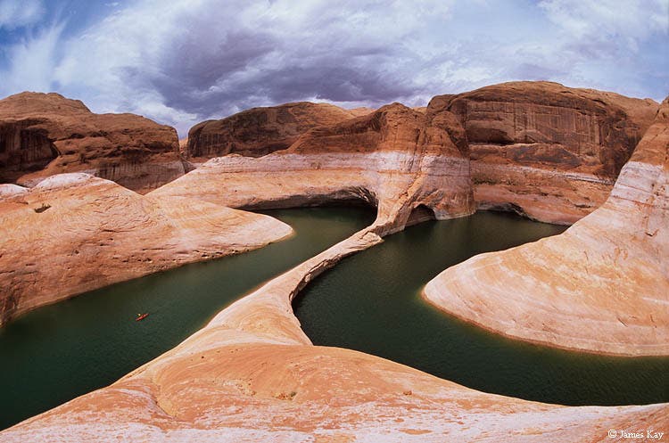 Reflection Canyon Kayaking (lower left) in Reflection Canyon beneath the towering 140-foot tall \