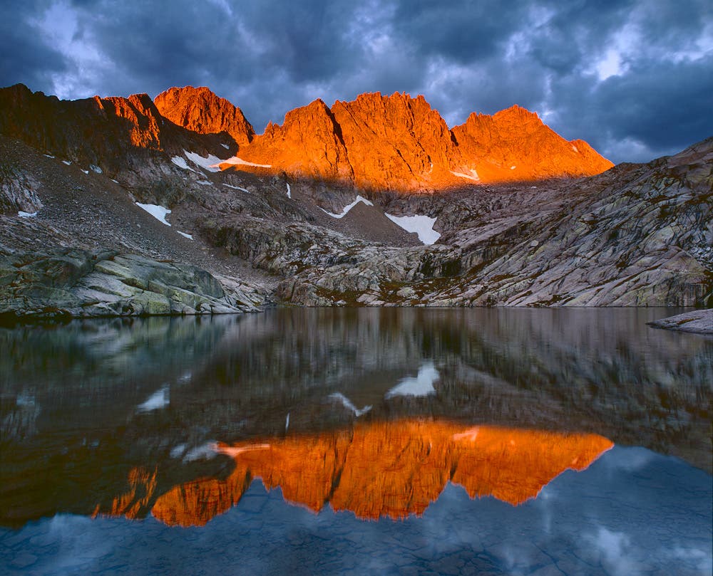 Sunlight Basin Alpenglow Sunrise Alpenglow sunrise light strikes Windom Peak (left) and Sunlight Peak (right) in Sunlight Basin. The peaks are two of Colorado's 54 \